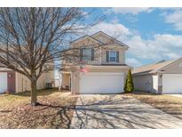 Charming two-story home with a well-maintained lawn and inviting curb appeal. American flag on front of house at 7730 Belmac Ln, Camby, IN 46113