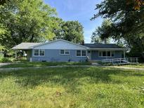Charming single-story home with a blue-painted brick exterior and a convenient wheelchair ramp at 9710 E 38Th St, Indianapolis, IN 46235