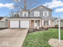 Charming two-story home with a well-manicured lawn, two-car garage, and inviting curb appeal at 11237 Baycreek Dr, Indianapolis, IN 46236