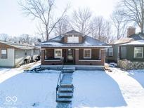 Brick home with front porch and steps, winter scene at 1307 W Congress Ave, Indianapolis, IN 46208