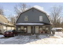 Gray two-story house with front porch, and a car parked in front at 151 Bakemeyer St, Indianapolis, IN 46225