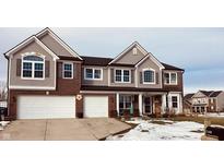 Two-story house with brick and siding, two-car garage, and snowy front yard at 2188 S Briarwood Dr, New Palestine, IN 46163