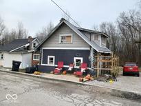 Charming gray house with red chairs on patio at 2790 Cabin Row, Martinsville, IN 46151