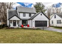 Charming two-story home boasts a well-manicured lawn, black trim, and attached two car garage at 333 S 4Th St, Zionsville, IN 46077