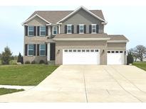 Two-story home with brick and siding, complemented by a well-manicured lawn and a spacious three-car garage at 373 Brianne Ln, Danville, IN 46122