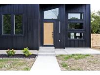 Modern black exterior with wood-toned front door and walkway at 459 N Concord St, Indianapolis, IN 46222