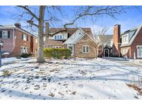 Brick home with snow-covered lawn, mature tree, and walkway at 5710 N Delaware St, Indianapolis, IN 46220