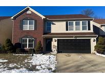 Two-story brick and vinyl home with a black garage door and landscaping at 6076 Bannister Ct, Indianapolis, IN 46236