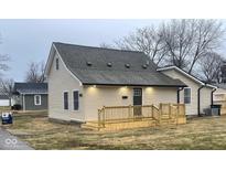 Beige house with new deck and landscaping at 633 S 17Th St, Elwood, IN 46036