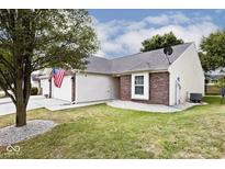 Brick ranch home with attached garage and landscaped yard at 6438 Emerald Springs Dr, Indianapolis, IN 46221