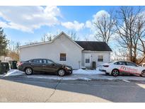 White house with dark car parked in front, in a snowy yard at 6951 E Michigan Rd, Waldron, IN 46182