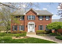 Charming brick two-story home with a well-manicured front yard and classic architectural details at 8552 E 550 S, Zionsville, IN 46077