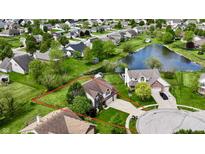Beautiful aerial view of home with a well maintained yard and a view of the pond at 861 Stardust Ct, Franklin, IN 46131
