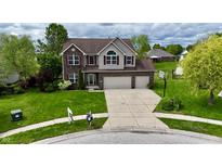 Charming exterior of a two-story home featuring a spacious driveway and well-manicured lawn at 861 Stardust Ct, Franklin, IN 46131