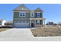 Two-story home with a two-car garage, manicured lawn, and welcoming front porch at 8703 Duncan St, Fortville, IN 46040