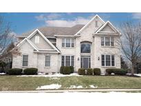 Brick two-story house with a three-car garage and landscaped lawn at 11474 Loch Raven Blvd, Fishers, IN 46037