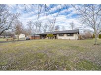 Brick ranch house with carport, spacious yard, and mature trees at 11614 Peacock Dr, Indianapolis, IN 46236