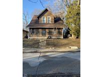 Two-story house with brown siding and a screened porch at 1420 W 23Rd St, Indianapolis, IN 46208