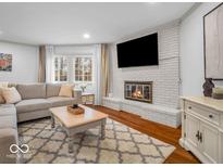 Cozy living room featuring a fireplace, and large sofa with ample natural light at 2224 Boston Ct # A, Indianapolis, IN 46228