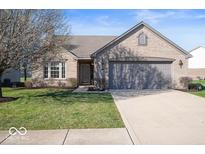 Brick ranch home with attached garage and landscaped lawn at 2322 Bainbridge Rd, Greenwood, IN 46143
