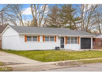 Charming brick home with a well-maintained lawn, garage, and updated accents at 2615 12Th St, Columbus, IN 47201