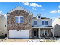 Two-story brick home with a white garage door and landscaping at 3174 Hemlock St, Whiteland, IN 46184