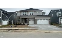 New construction two-story home with gray siding, brick accents, and a two-car garage at 5326 Noble Crossing W Pkwy, Noblesville, IN 46062