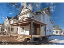 Two-story home with large front porch and mature tree. Needs renovation at 605 Hendricks St, Anderson, IN 46016