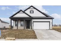 Charming two-story home featuring a covered porch and attached garage at 7419 Legends Way, Whitestown, IN 46052