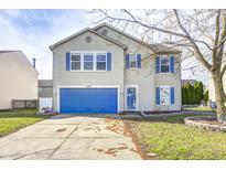 Charming two-story home featuring blue shutters and a matching garage door enhancing its curb appeal at 10069 Boysenberry Dr, Fishers, IN 46038