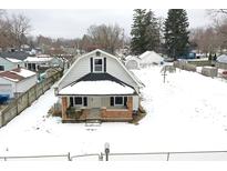 Aerial view of charming house with snow covered yard at 1175 Central Ave, Noblesville, IN 46060
