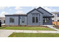 Contemporary gray home featuring a well-manicured lawn, clean lines, and modern architectural details at 1674 Solebar Way, Westfield, IN 46074