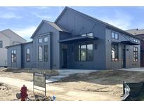 Modern home featuring sleek architecture, a dark exterior, and ample windows at 1674 Solebar Way, Westfield, IN 46074