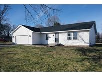 Newly built home with white siding, a two-car garage, and a landscaped lawn at 1850 W Deaver Rd, Columbus, IN 47201