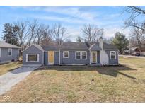 Charming single-story home with a gray exterior, yellow doors, and a well-maintained lawn at 1901 E 68Th St, Indianapolis, IN 46220