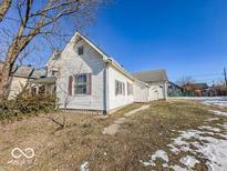 White house with gray roof, small yard, and partial snow cover at 1913 S Talbott Se St, Indianapolis, IN 46225