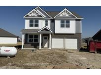 Two-story home showcasing a brick and vinyl exterior, a two-car garage, and modern architectural details at 2162 Warbler St, Danville, IN 46122