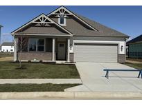 Charming single-story home featuring a brick and siding facade, well-kept lawn, and attached two-car garage at 2190 Warbler St, Danville, IN 46122