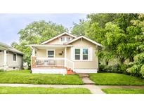 Charming single-story home featuring a cozy front porch and well-maintained lawn at 361 S Spencer Ave, Indianapolis, IN 46219