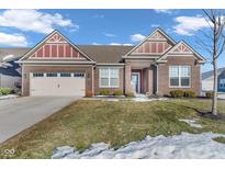 Brick ranch home with a two-car garage and landscaped lawn at 5246 Parkhurst Xing, McCordsville, IN 46055