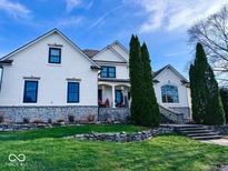 Two-story white brick house with stone accents, landscaping, and a large front porch at 5465 S State Road 75, Jamestown, IN 46147