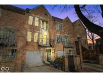 Brick townhome with attached garage and balcony at 588 E Vermont St, Indianapolis, IN 46202