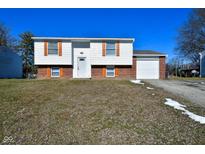 Brick ranch house with attached garage and landscaped lawn at 9028 Caminito Ct, Indianapolis, IN 46234