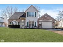 Charming two-story home with a brick facade, well-maintained lawn, and attached two-car garage at 10229 Canal Way, Noblesville, IN 46060