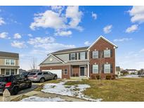 Brick two-story house with attached garage and landscaped lawn at 1284 Jesse Ct, Greenwood, IN 46143
