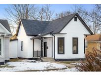 Charming white house with black accents and a snow-covered front yard at 1730 Union St, Columbus, IN 47201