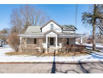 A charming two-story home with a wraparound porch, needing some TLC at 2088 E Eden Rd, Greenfield, IN 46140