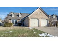 Charming brick home featuring a two-car garage and well-maintained lawn, blending comfort and curb appeal at 2926 Village Park N Dr, Carmel, IN 46033
