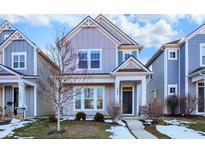 Two-story home with gray siding, dark brown door, and landscaping at 344 Evans St, Indianapolis, IN 46222