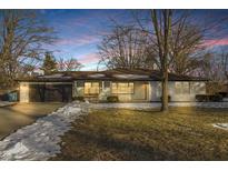 Updated ranch home with a charming curb appeal and a spacious front yard at 5341 Fenmore Rd, Indianapolis, IN 46228